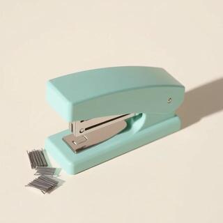 Compact mint stapler on ivory sheet