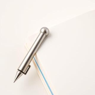 Mini pen with clip attached to a small notebook
