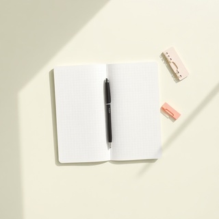 Ivory notebook flatlay with mint elastic band